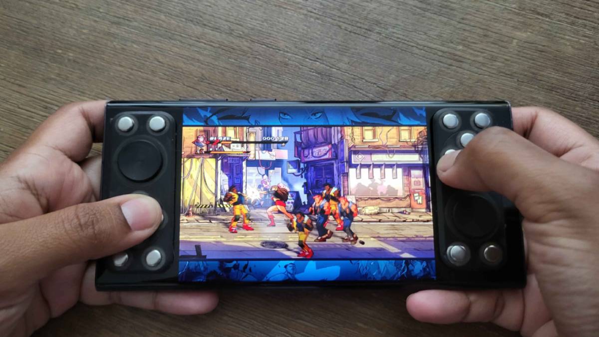Close-up of thumbs on the tactile BandController buttons mid-game